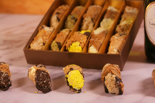 Assorted cannoli pastries in a box with Champagne. Luxury Gifts